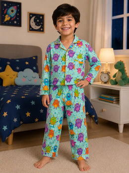 Child wearing a colorful rainbow and dinosaur print pajama set